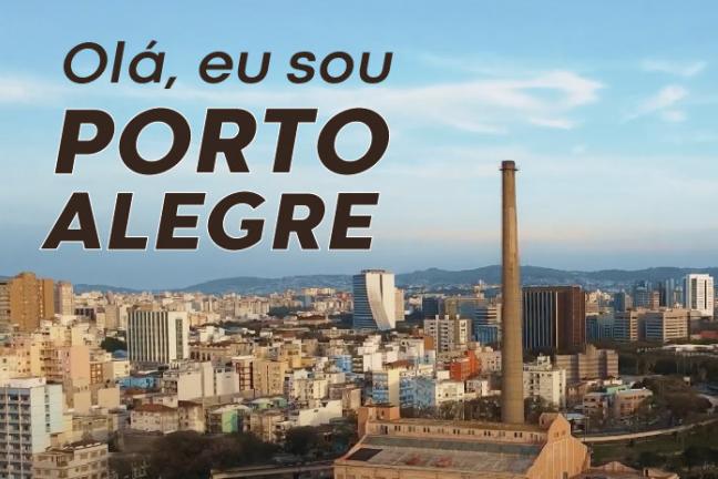 Imagem de prédios de Porto Alegre, com a Usina do Gasômetro em primeiro plano. Sobre os prédios, no céu azul, o seguinte texto: Olá, eu sou Porto Alegre